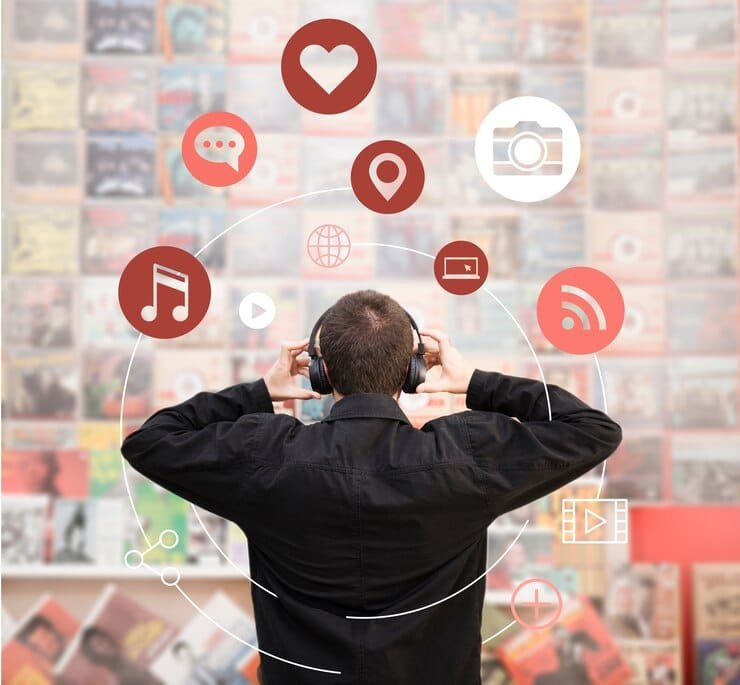 a boy is listening the music with headphones